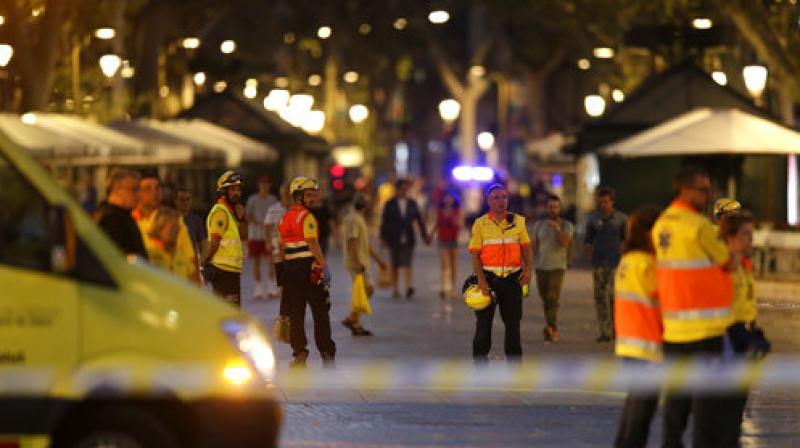 Emergency workers stand on a blocked street in Barcelona, Spain, Thursday. (Photo: AP)