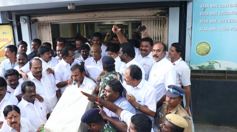 Police personnel take the armour in a container after the Bank of India, Anna Nagar Branch, Madurai, authorised the collector Veera Raghava Rao to take it to Pasumpon on Friday. AIADMK ministers also seen. (Photo: DC)