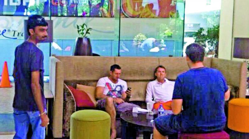 A screengrab from Al-Jazeeras sting operation shows alleged fixer Aneel Munawar (left) in a hotel lobby in Sri Lanka. Former England players Graeme Swann and Tim Bresnan are also seen.