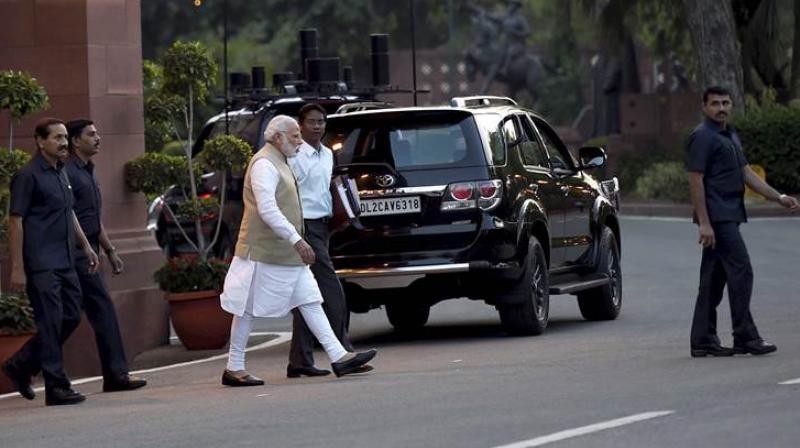 Prime Minister Narendra Modi walks for a Cabinet meeting at Parliament Library in New Delhi. (Photo: PTI)