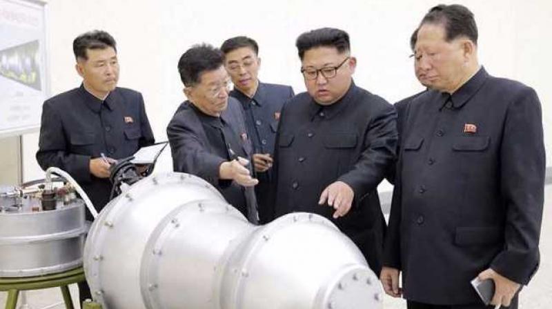 Latest images released by the North Korea show Kim Jong Un inspecting a device with metal casing. (Photo: AFP)