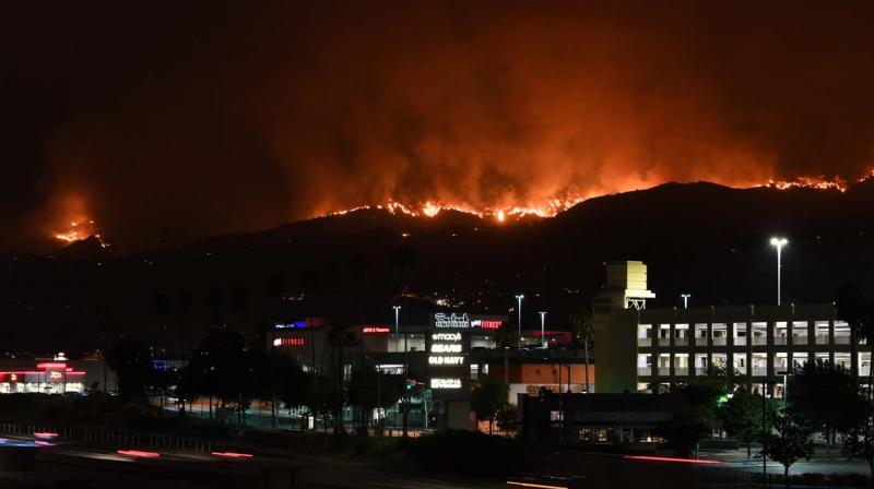 The La Tuna Canyon fire burns in the hills above Burbank, California, early September 2, 2017. The brush fire which quickly burned 2,000 acres started on September 1 and was being driven by heat wave temperatures and high winds. (Photo: AFP)