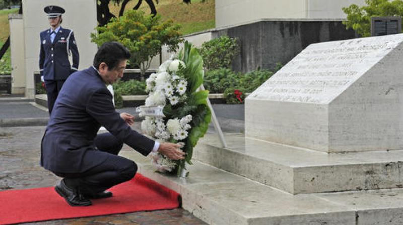 Japanese Prime Minister Shinzo Abe visits the National Memorial Cemetery of the Pacific to place a wreath at the Honolulu Memorial, Monday on Dec. 26, 2016, in Honolulu. (Photo: AP)