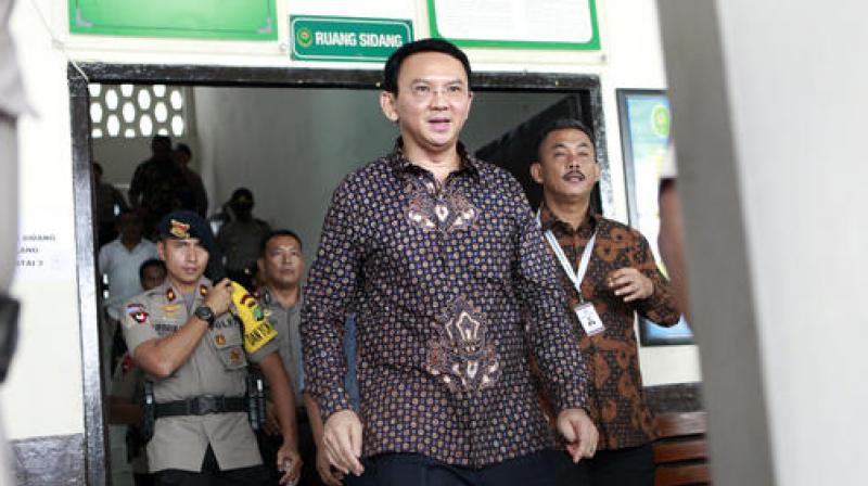 Jakarta Governor Basuki Tjahaja Purnama walks out of a courtroom after his trial at North Jakarta District Court in Jakarta, Indonesia. (Photo: AP)