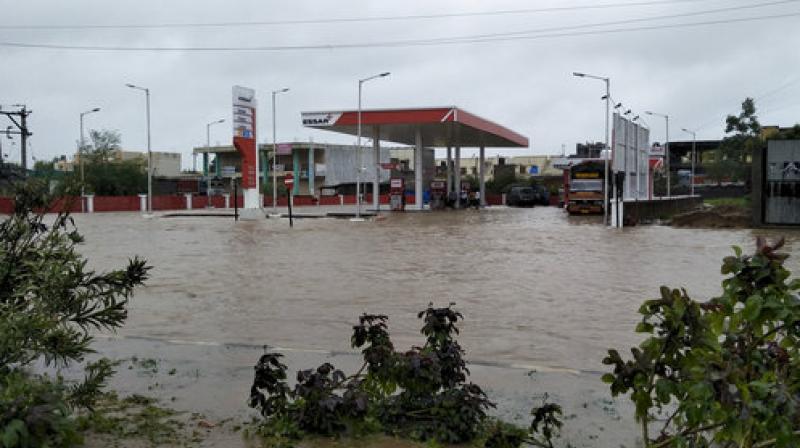 A fuel pump is surrounded by flood waters following heavy monsoon rains in Deesa, Gujarat state, India, Tuesday, July 25, 2017. The death toll in Gujarat has risen to 70 since the start of the monsoon season, which runs from June through September. (Photo: PTI)