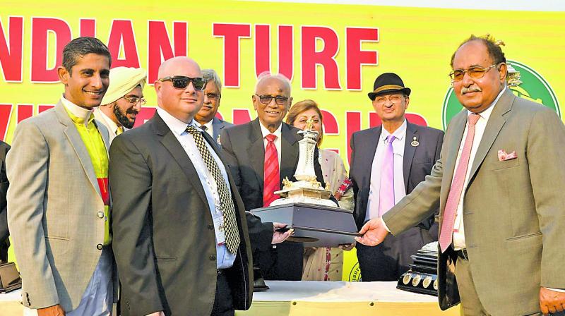 Hyderabad Race Club chairman R. Surender Reddy (centre) presents the winners trophy to Breeder Sultan Singh (right), trainer J. E. Mckeown (second from left) and jockey Y. S. Srinath (left) after Adjudicate won the Indian Turf Invitation Cup at the Malakpet Race Course in Hyderabad on Sunday.