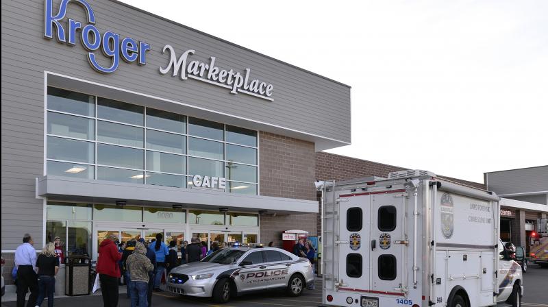 Employees wait outside the entrance of a Kroger grocery following a shooting that left two people dead and a suspect in custody on Wednesday. (Photo: AP)