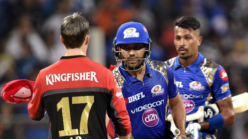 AB de Villiers greets Mumbai Indians batsman Rohit Sharma after their win during the IPL match against Royal Challengers Bangalore at Wankhede Stadium in Mumbai on Monday. (Photo: AP)