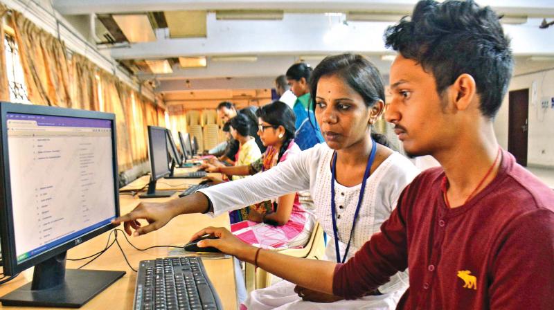 Anna University volunteers helping students to register their applications online for engineering counselling on Monday (Photo: DC)