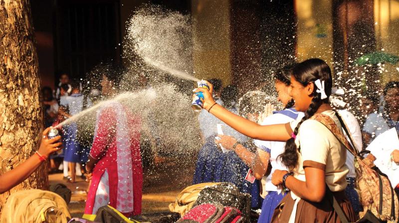 Elated students of Sacred Heart Convent Girls High School celebrate after the final SSLC exam with snow spray in Thrissur on Thursday.  (Photo: Anup K. Venu)