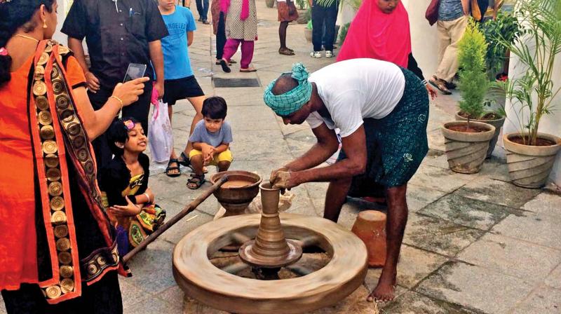 An artisan showing a live demo of pot making at the  heritage festival. (Photo: DC)