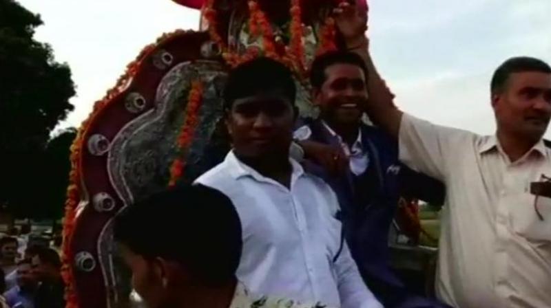 The groom Sanjay Jatav (C) took a historic ride on Sunday after he entered the Thakur community-dominated village in presence of a heavy police force. (Photo: ANI)