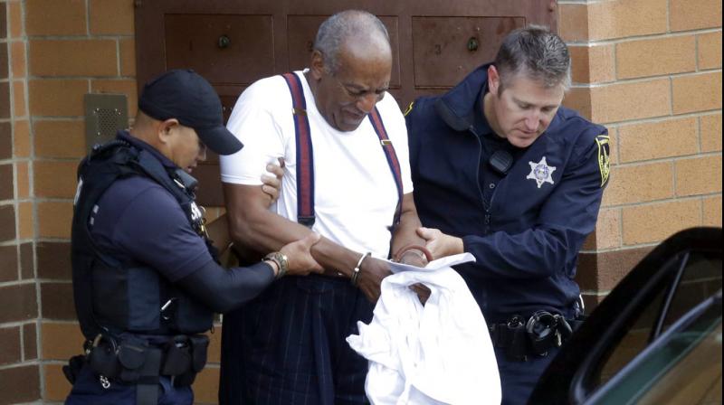 Bill Cosby is escorted out of the Montgomery County Correctional Facility. (Photo: AP)