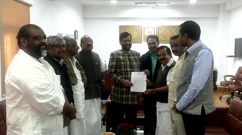 Opposition leader Ramesh Chennithala hands over a memorandum to Union food and civil supplies minister Ramvilas Paswan in New Delhi on Wednesday demanding restoration of the ration quota. Also seen are N.K. Premachandran, MP, M. Ummar, MLA, Anoop Jacob, MLA, CMP leader C.P. John, JDU leader Varghese George, K. C. Joseph, MLA, and former Union food and civil supplies minister K.V. Thomas, MP.