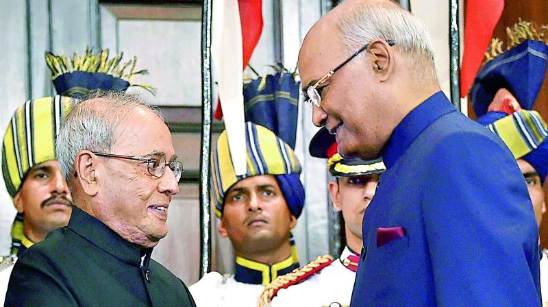 Newly-elected President Ram Nath Kovind and his predecessor Pranab Mukherjee exchange chairs after the former took oath, at a special ceremony in the Central Hall of Parliament in New Delhi on Tuesday. (Photo: PTI)