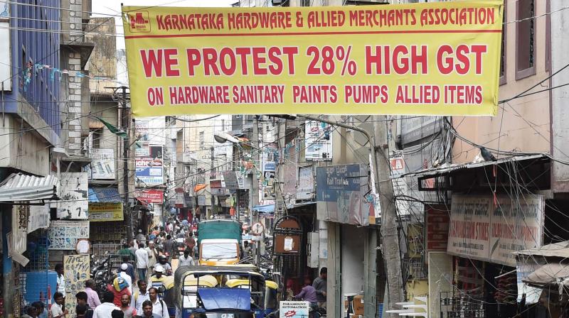 Karnataka Hardware and Allied Merchants Association put up a banner protesting  GST on SP Road, in Bengaluru on Thursday(Photo: DC)