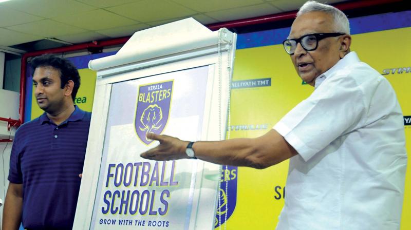 erala Football Association President KMI Mather points to the logo of Kerala Blasters Football Schools as the club CEO Varun Tripuraneni looks on, at the Jawaharlal Nehru Stadium in Kochi on Friday.  (Photo: DC )