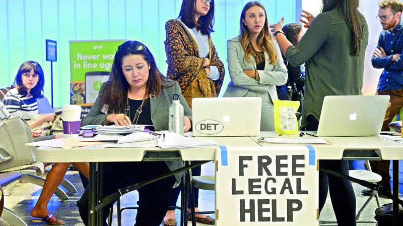 Immigration attorneys offer services at the Los Angeles airport as the new travel ban affects citizens from six Muslim-majority countries. (Photo: AP)
