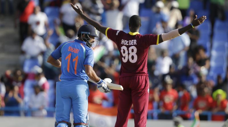 West Indies captain Jason Holder celebrates dismissing Indias Mohammed Shami to beat India for 11 runs during their fourth ODI cricket match(Photo: AP)