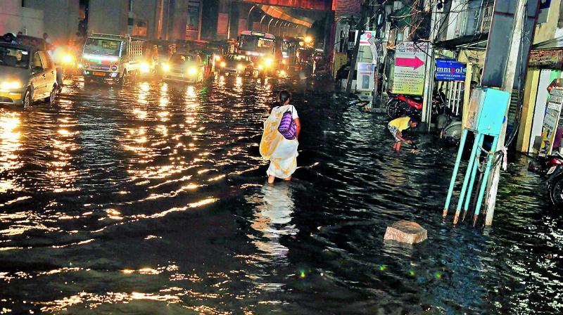 A woman wades through rainwater on Malakpet main road as heavy rains lashed the twin cities on Thursday evening.  (Photo: DC)