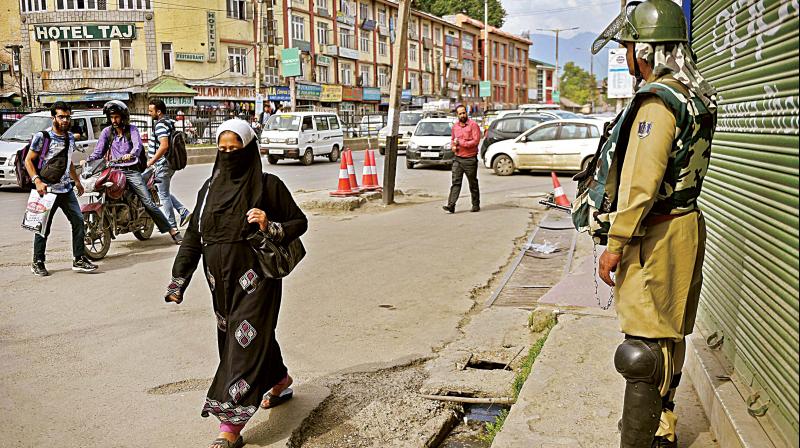 A security person stands guard in Srinagar on Thursday (Photo: PTI)