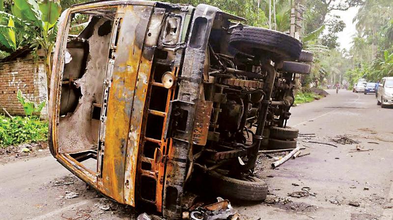 A burnt vehicle seen at a road after a communal riot at Baduria in North 24 Pargana district of West Bengal (Photo: PTI)
