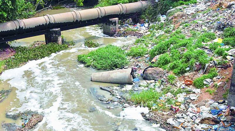 Froth started flowing through the Nalla cheruvu lake to an open nala near Uppal  (Photo: DC)