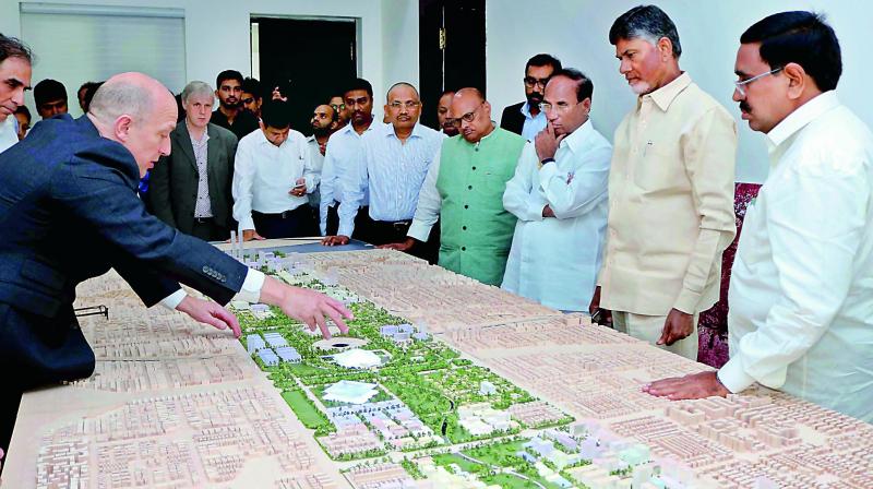 Norman and Faster representative Chris Bob explain the details on AP capital plans to Chief Minister N. Chandrababu Naidu at his camp office in Vijayawada on Wednesday	( Photo: DC)