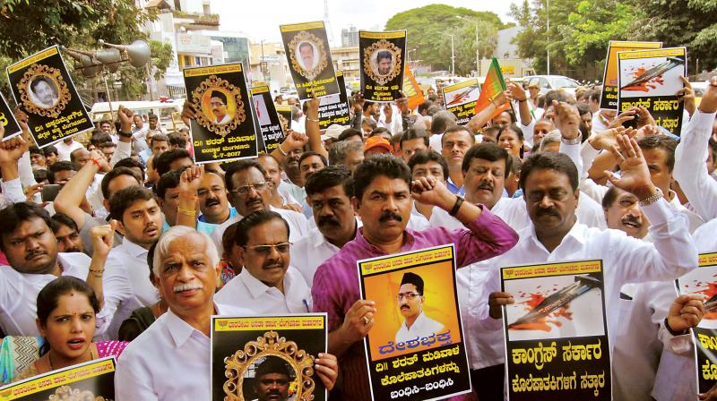 BJP leaders and workers led by former Deputy CM R Ashok stage a protest in Bengaluru on Wednesday condemning the murder of a RSS worker, Sharath Madivala, in Mangaluru recently