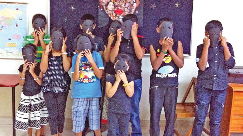 Children at Prayatna wear black masks and fight color bias at a book club session held recently (Photo: DC)