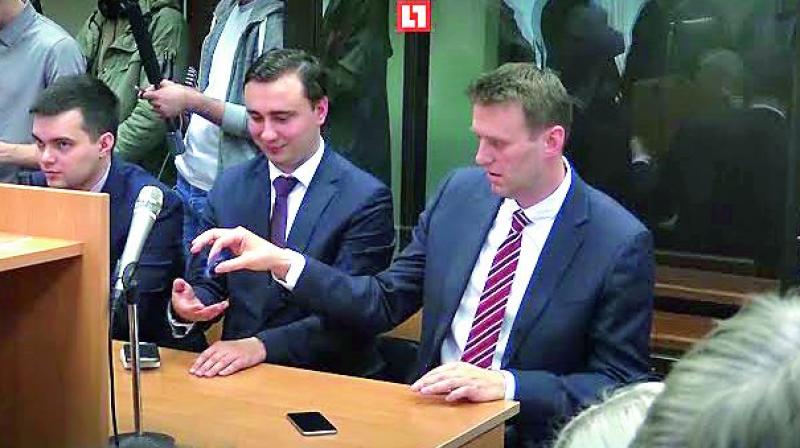 Kremlin critic Alexei Navalny posted a video of himself sitting in a court playing with a fidget spinner.