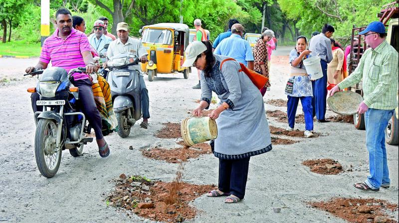 Over 70 people from various colonies across Secunderabad cantonment area came forward to fill the potholes at AOC road, opposite the NSG on Sunday