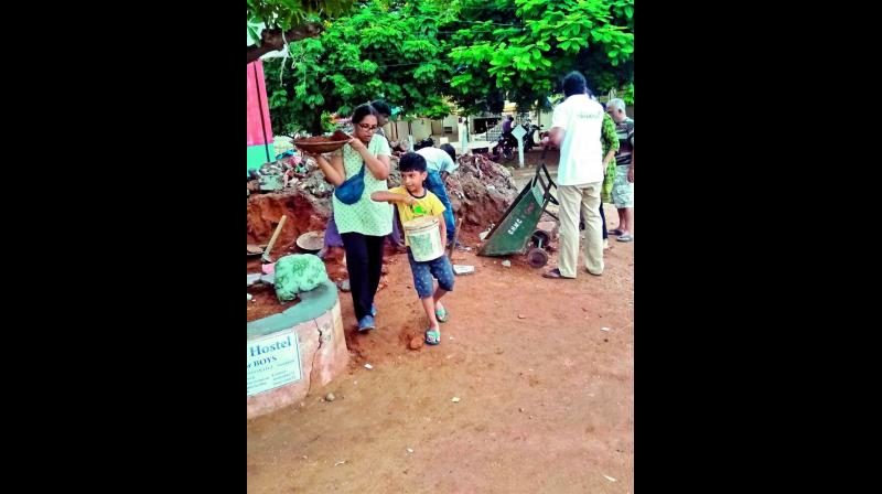 Residents of Secunderabad Cantonment Board fill up a road at Neredmet the roads with mud (Photo: DC)