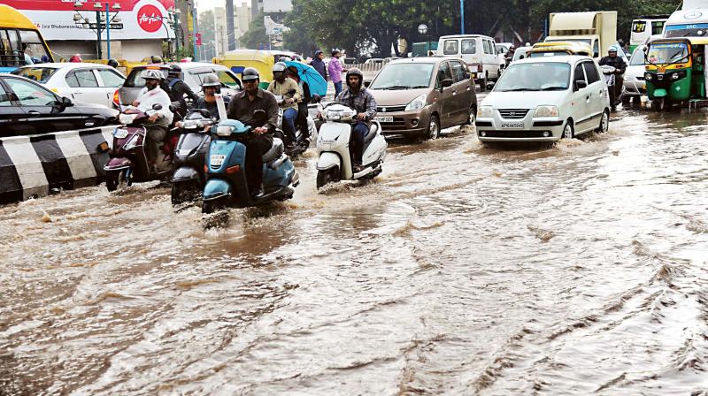 Traffic moves through flooded roads in Bengaluru