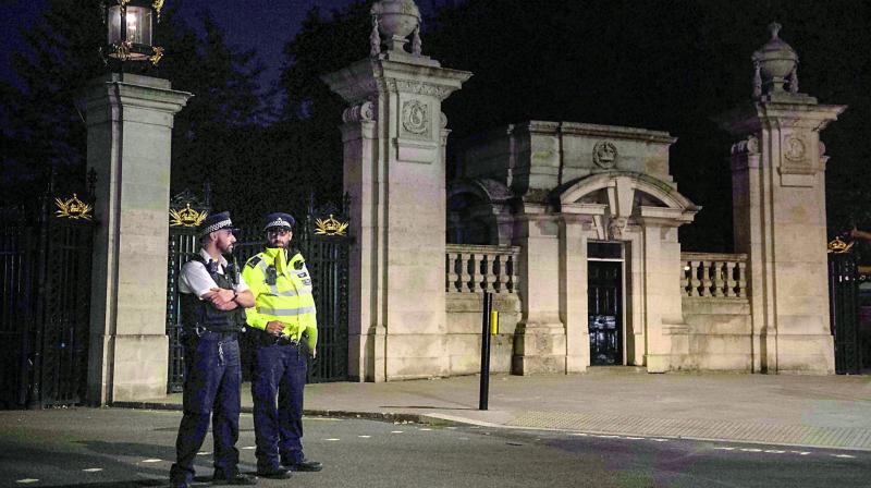 Police stand guard outside the palace on Saturday (Photo: AFP)