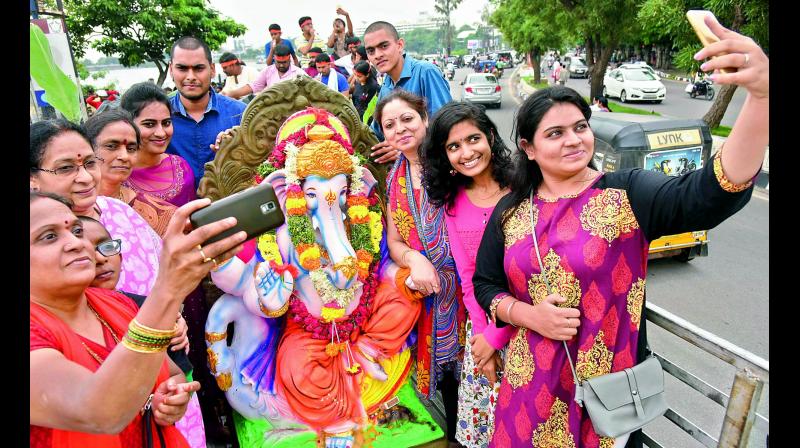 People taking selfies at Hussainsagar during the third day of Ganesh  nimarjanam on Saturday.