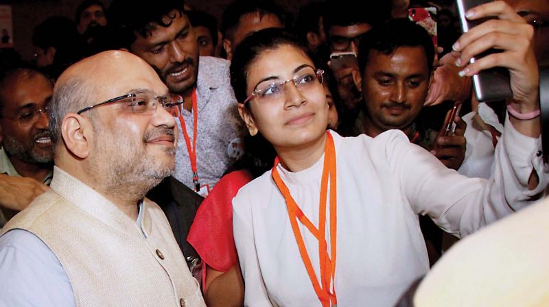 A girl takes selfie with BJP chief Amit Shah in Ahmedabad on Sunday (Photo: PTI)