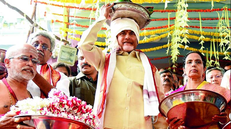 Chief Minister N. Chandrababu Naidu and his wife Bhuvaneshwari carry Pattu Vastram to Goddess Kanakadurga in Vijayawada on Wednesday. (Photo: DC)