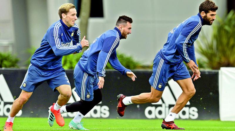 Argentinas Lionel Messi (centre) at a training session in Buenos Aires, on Tuesday. They are presently fifth on the points table (Photo: AFP)