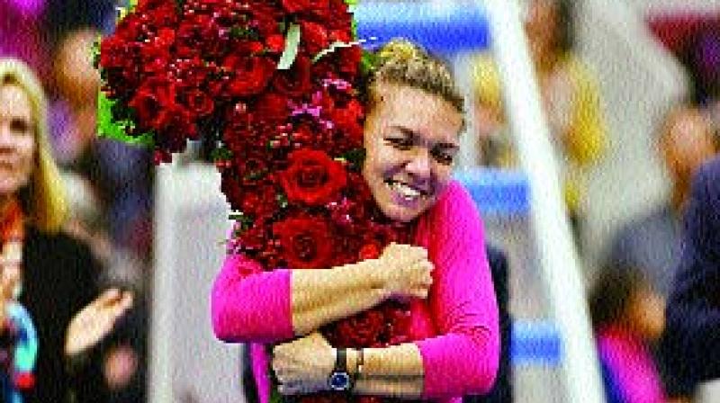 Simona Halep celebrates after taking the top ranking upon reaching the China Open final on Saturday (Photo: AFP)
