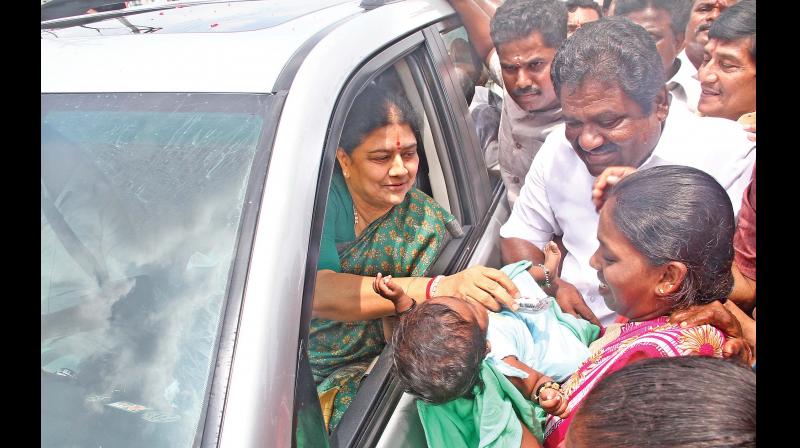V.K. Sasikala greets a child on Wednesday on her way back after visiting her ailing husband Natarajan in the hospital (Photo: DC)