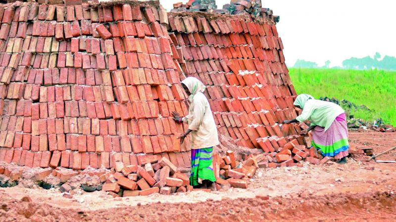 Women work at a brick kiln. A variety of reasons has been cited for the rise in brick prices (Photo: DC)