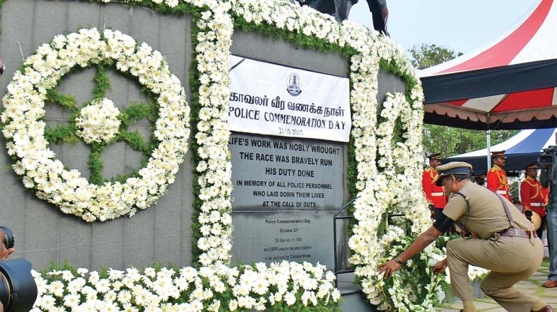 Director General of Police T.K. Rajendran places a wreath honouring slain policemen from the state to mark Police Commemoration Day. (Photo: DC)