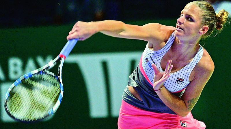 Karolina Pliskova of the Czech Republic plays a shot against Venus Williams of the U.S. during their WTA Finals tennis tournament in Singapore on Sunday. (Photo: AFP)