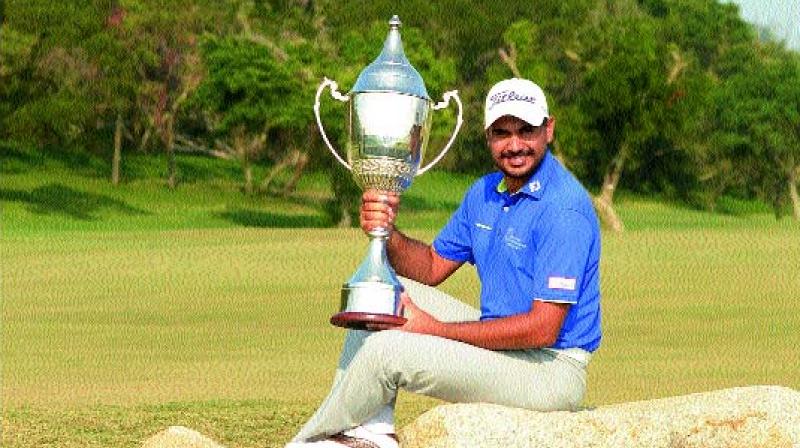 Gaganjeet Bhullar poses with the trophy after winning the Macau Open on Sunday.