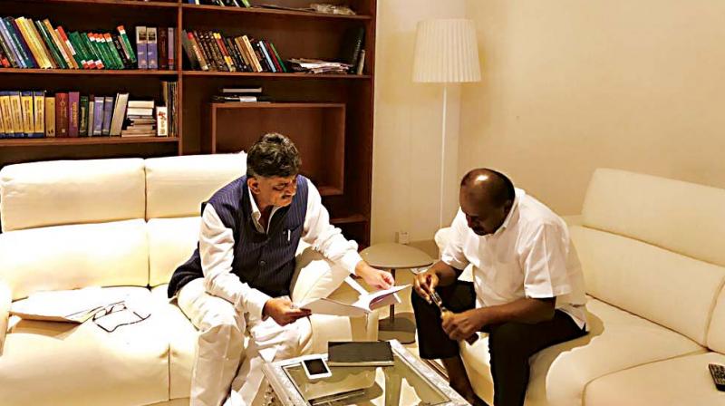 Energy Minister D.K. Shivakumar and JD(S) state president H.D. Kumaraswamy meet to discuss the power purchase scam.