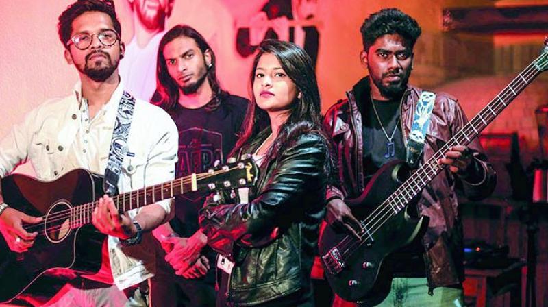 Lead guitarist Nitin Dominic Dsouza,  percussionist Obied Kariwow, vocalist Karen Renita Mario and bassist Ronith Michael  of the band The Three Of Us & Her