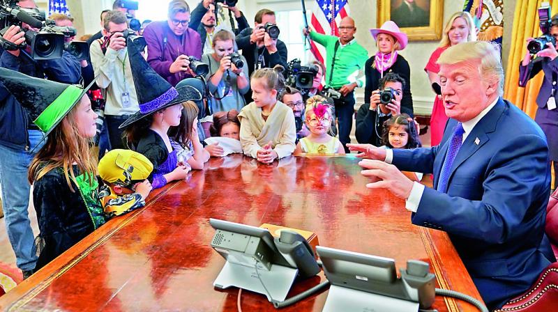 President Donald Trump meets with children dressed in their Halloween costumes in the Oval Office of the White House on Saturday. (Photo: AP)