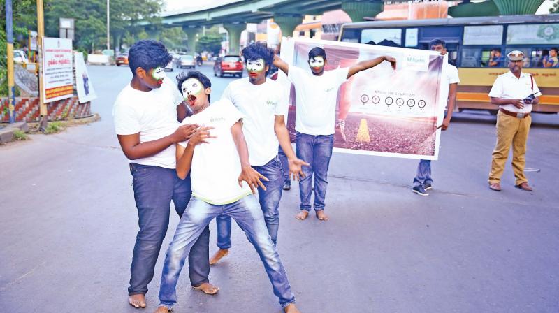 Mime artistes perform on the theme of BE FAST on World Stroke Day at traffic signals near Adyar on Sunday. (Photo: DC)