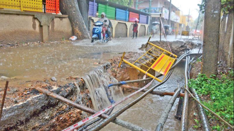 Incomplete stormwater drain work at Periyar Nagar in Korattur has narrowed the road and rains have increased commuters pain. With a school in the area, open pits pose a threat to road users. (Photo: DC)